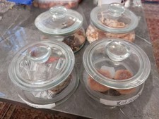 glass storage jars with lids, containing various food items.