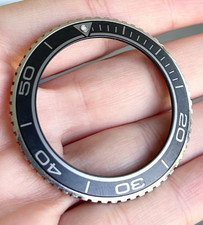 An Omega Seamaster Planet Ocean Wristwatch Bezel & Extra Parts.