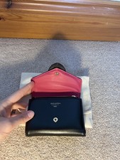 Brand New black leather Louis Vuitton purse with pink ligning