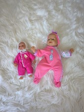 Two Soft bodied baby dolls with outfits.