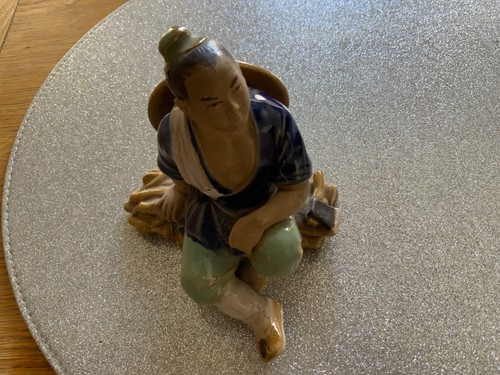 Shiwan mudman sitting with - sitting, axe
