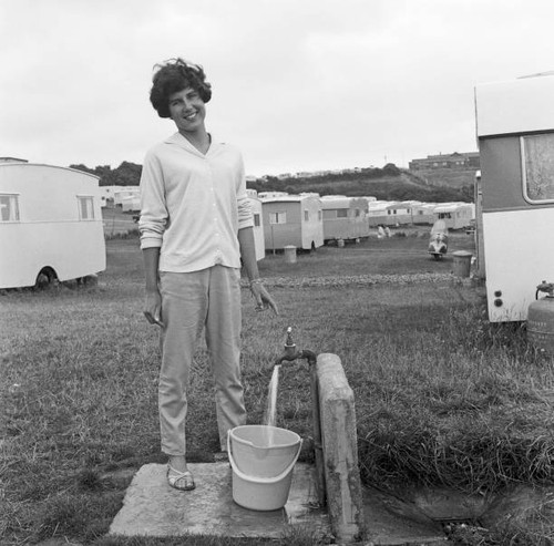 Holidaymaker collects water - , at