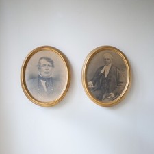 pair of large oval gold picture frames with pencil drawing