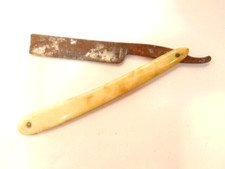 old straight razor with white