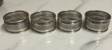 4 x silver napkin rings marked