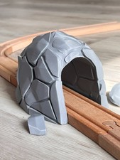Train track tunnel with rocks