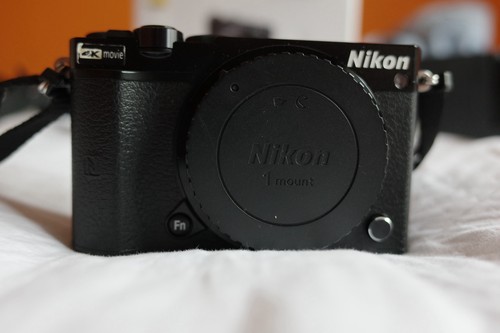 Black nikon with 10 - 1, j5