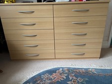 set of three chest of drawers and two bedside cabinets
