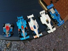 Five toy cars. Hotwheels F1