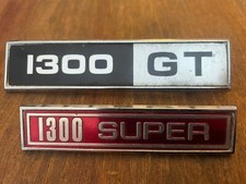 TWO VINTAGE CAR BADGES -