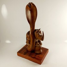 Wooden Sculpture Featuring a Cobra Intertwined with a Rhino, on a Wooden Base