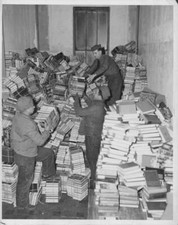 Army truck drivers loading up piles books, destined for men front  Old Photo