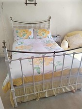 Genuine Edwardian cast iron bedframe with brass rails around a base and mattress