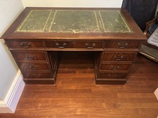 antique desk with nine lockable drawers. The leather top needs replacing.