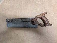 Antique dovetail saw. Carved leaf pattern on handle.  Brass fittings & medallion