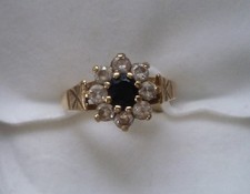 LADIES 9CT YELLOW GOLD RING WITH CENTRAL BLUE STONE WITH CLEAR STONES  SIZE I