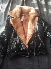 Black patent leather jacket from Topshop with fur collar and lining. Size 10,