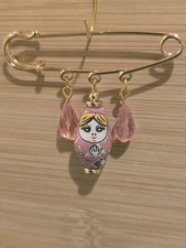 Golden safety pin style brooch