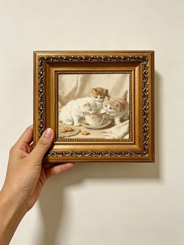 Three kittens licking teacup - three,