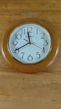 Howard Miller Wall Clock. Champayne Oak Finish. 9 1/2 in. Battery not included