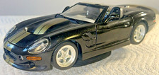 Shelby Series 1 BURAGO 1999 1:18 Scale Model Convertible Black and Gold on Stand