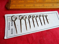 AN EARLY SET OF SUPERIOR BRAND FISHING ROD RINGS ON ORIGINAL CARD