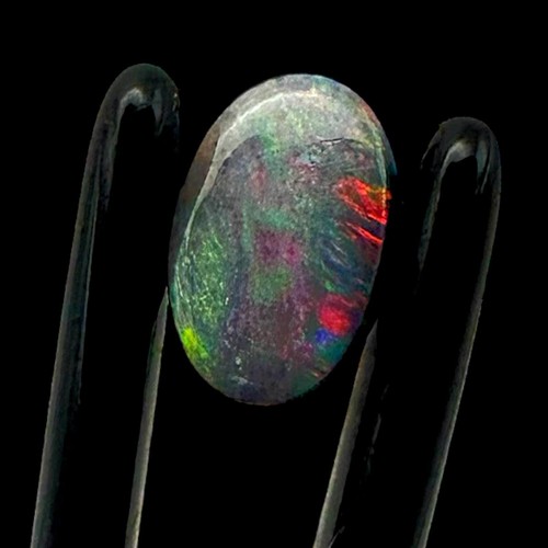 Black opal cabochon with red