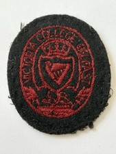 Victoria College Belfast Old Cloth Cap Badge.