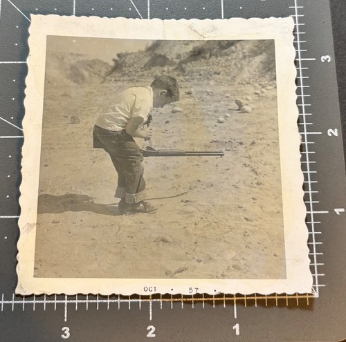 1950s boy loading gun - loading,