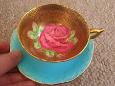 VERY RARE PARAGON FLOATING ROSE CUP & ASSOCIATED SAUCER, LARGE ROSE ON GOLD GILD