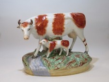 ANTIQUE STAFFORDSHIRE LARGE COW & CALF FIGURINE ON RAISED OVAL BASE CIRCA 1880'S