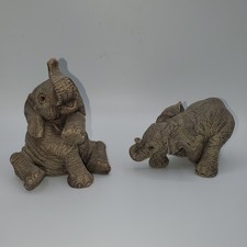 2 vintage "The Herd" elephant figurines by artist Martha Carey