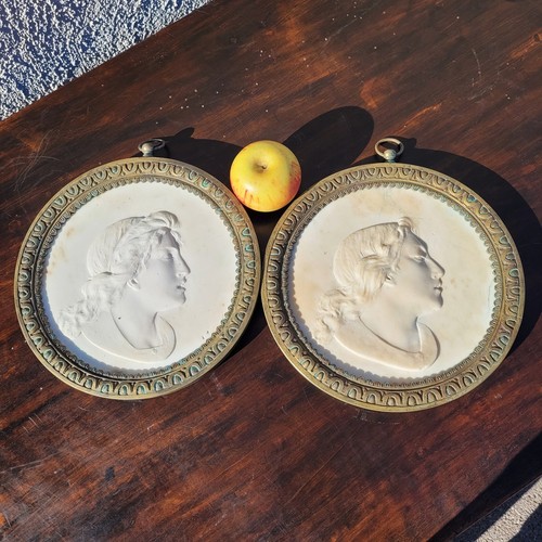 Two framed sculpted - , marble