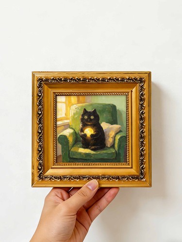 Black cat holding glowing orb - black,
