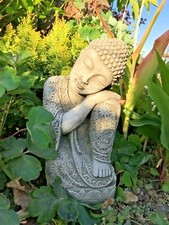 Buddha sitting head on knee