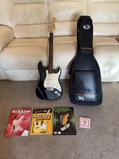 Fender squier strat electric guitar with gig bag and books