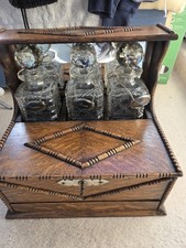 Oak And Silver Plate Tantalus With 3 Decanters, 3 Glasses And Games Drawer