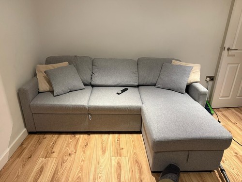 Shaped grey sofa bed with - shaped,