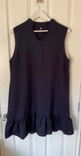 Navy blue knee length sleeveless summer dress with ruffle hem