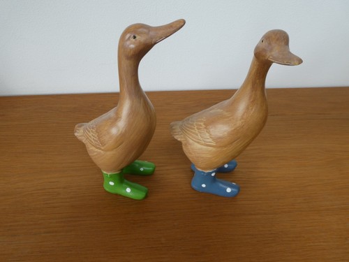 Two solid wooden ducks with - two,