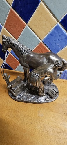 Farrier shoeing horse - a,