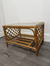 Vtg bamboo and rattan coffee table with a glass top and a lower slatted shelf