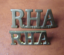 Two vintage Royal Horse Artillery RHA brass shoulder titles. British army.