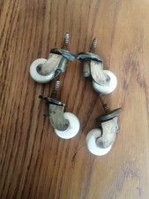 SET OF 4  ANTIQUE BRASS AND PORCELAIN CERAMIC  FURNITURE CASTORS . 