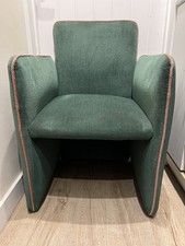 Green fabric armchair with pink piping