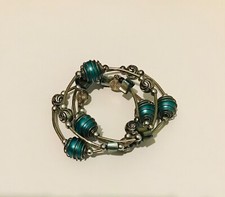 Bracelet Beaded metal wrap round blue and silver design and charm detail. Offers