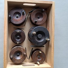 Six vintage wooden fishing reels in various sizes and styles