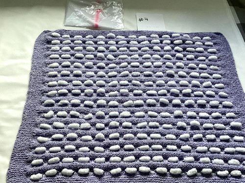 Hand knitted blue white pom - hand,