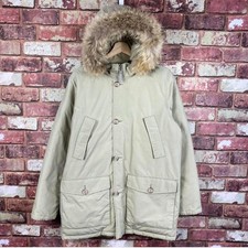 Women’s beige Woolrich coat with raccoon fur collar, size 16
