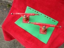 Red pair of skateboard trucks